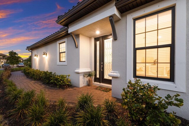 entrance to property with stucco siding