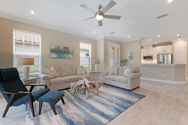 living area featuring light wood-style floors, recessed lighting, visible vents, and ornamental molding