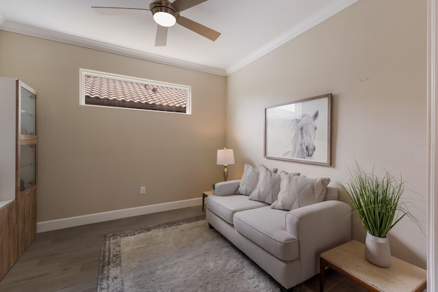 living room with ceiling fan, crown molding, baseboards, and wood finished floors