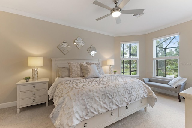 bedroom featuring baseboards, visible vents, light colored carpet, ceiling fan, and crown molding