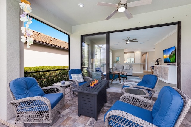 view of patio featuring an outdoor living space with a fire pit and ceiling fan