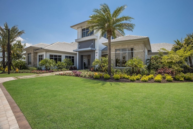 view of front of house featuring a front lawn and stucco siding