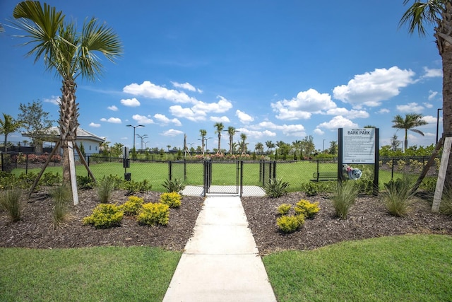 view of property's community with a yard, a gate, and fence