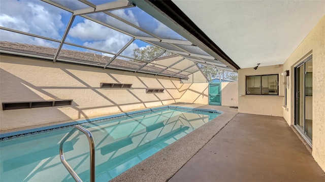 pool featuring glass enclosure and a patio