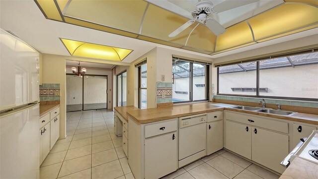 3692 Glen Oaks Manor Dr, Sarasota, FL 34232 - kitchen featuring white appliances, a sink, light tile patterned flooring, ceiling fan, and a peninsula