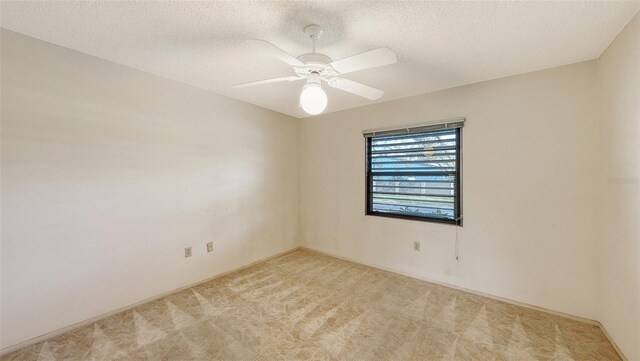 3692 Glen Oaks Manor Dr, Sarasota, FL 34232 - spare room with light colored carpet, a ceiling fan, and a textured ceiling