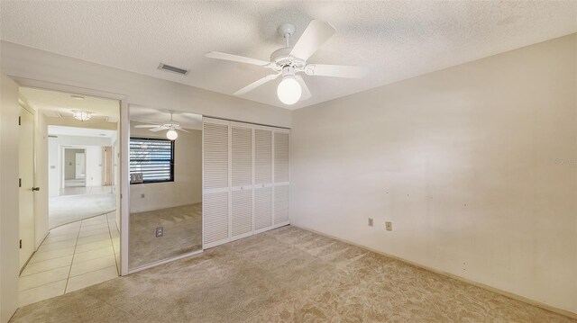 3692 Glen Oaks Manor Dr, Sarasota, FL 34232 - unfurnished bedroom with carpet, a closet, a textured ceiling, and ceiling fan