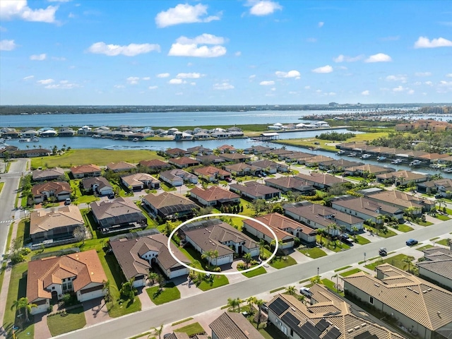 birds eye view of property featuring a water view and a residential view