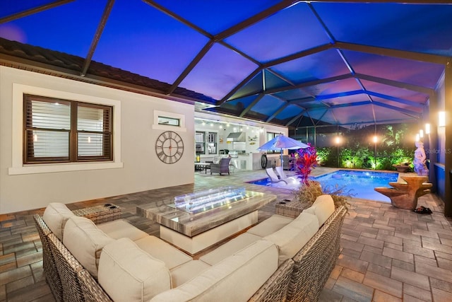 outdoor pool featuring glass enclosure, outdoor lounge area, and a patio