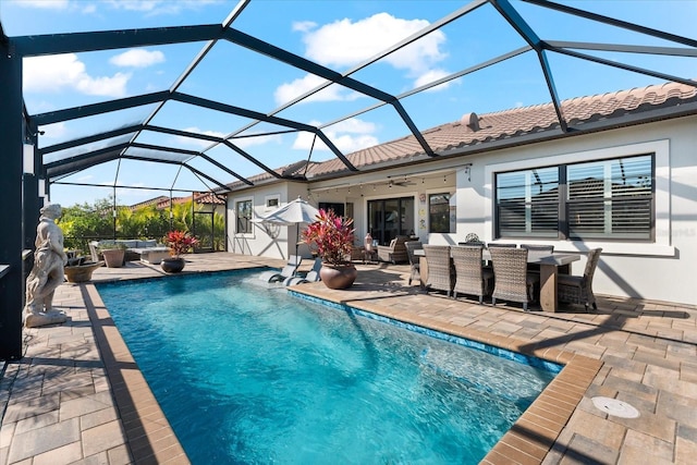 pool featuring glass enclosure, ceiling fan, a patio area, an outdoor living space, and outdoor dining space