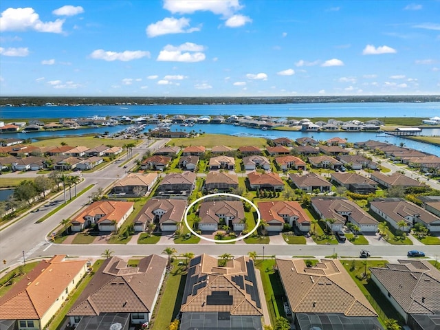 bird's eye view featuring a water view and a residential view