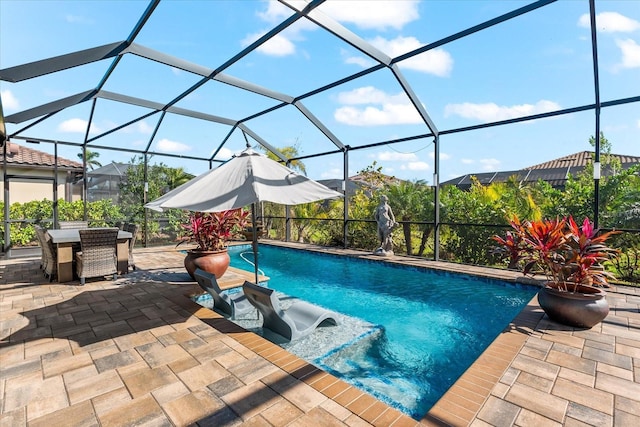 outdoor pool with glass enclosure and a patio