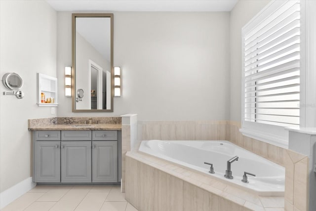 full bathroom featuring a garden tub, tile patterned floors, and vanity