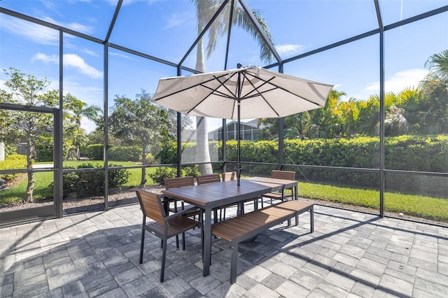 view of patio / terrace with outdoor dining space and glass enclosure