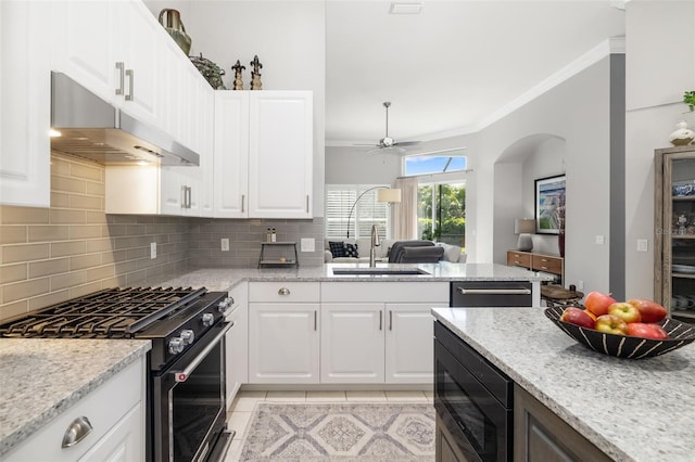 kitchen with light tile patterned floors, under cabinet range hood, ornamental molding, backsplash, and black appliances