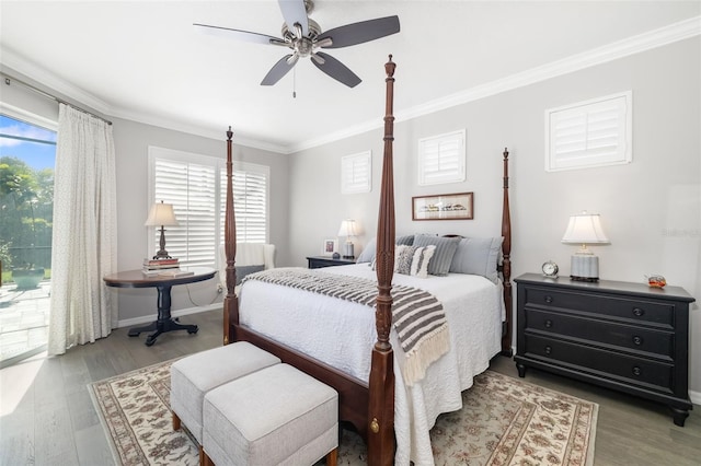 bedroom with baseboards, crown molding, and wood finished floors