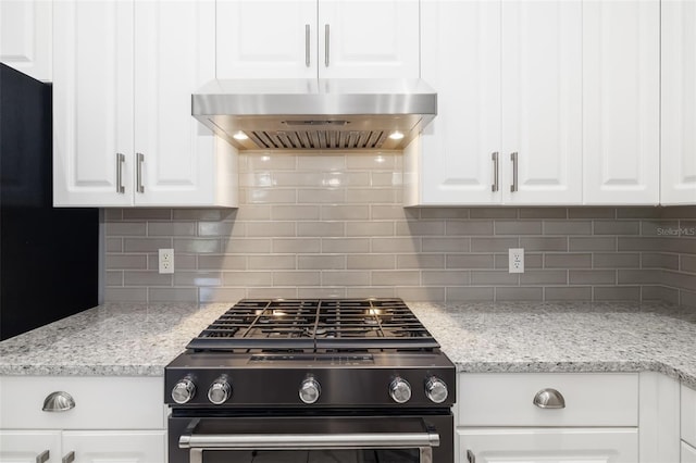 kitchen with gas range oven, extractor fan, white cabinetry, and decorative backsplash