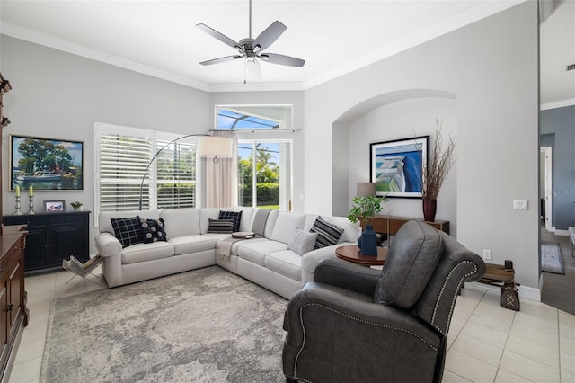 living room featuring light tile patterned floors, ornamental molding, a ceiling fan, and baseboards