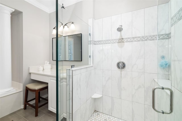 full bathroom featuring crown molding, tile patterned flooring, decorative columns, and a shower stall