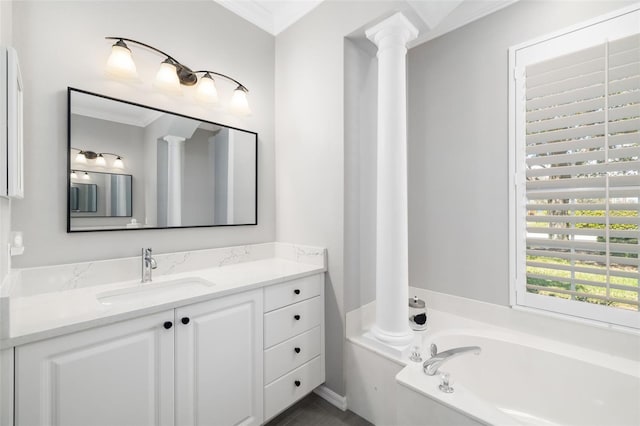 bathroom with ornamental molding, a garden tub, vanity, and ornate columns