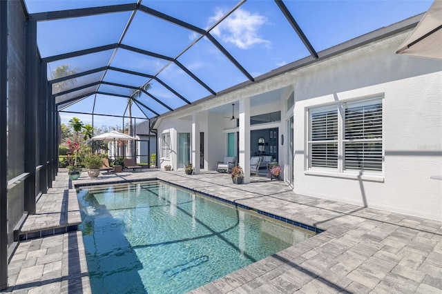 pool with a patio area, a lanai, and a ceiling fan