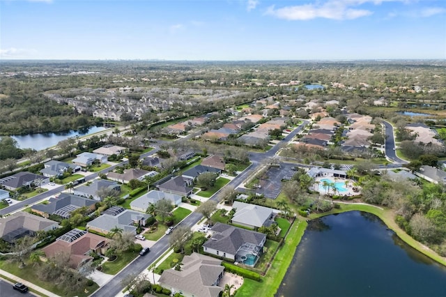 drone / aerial view with a water view and a residential view