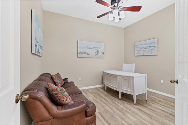 home office featuring light wood-type flooring, baseboards, and a ceiling fan