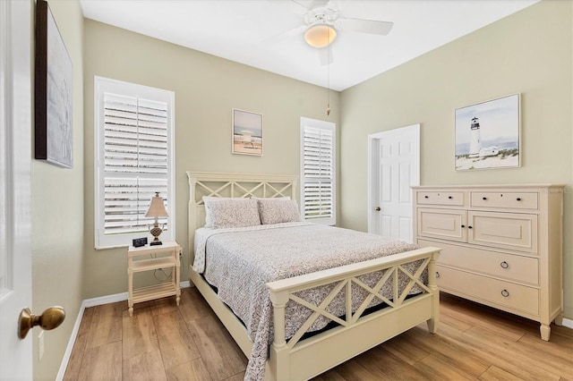 bedroom featuring light wood finished floors, ceiling fan, and baseboards