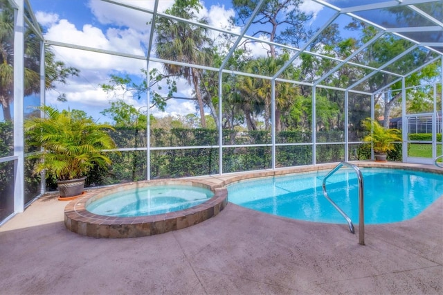 view of swimming pool featuring glass enclosure, a patio, and a pool with connected hot tub