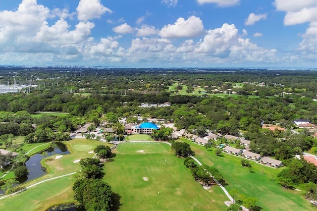 aerial view featuring view of golf course and a wooded view