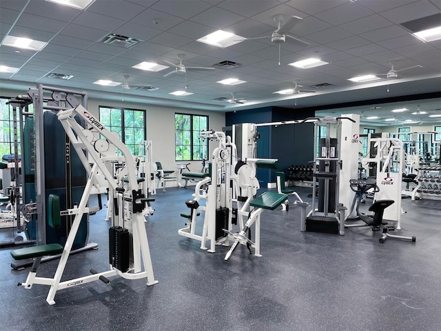 gym with a paneled ceiling and visible vents