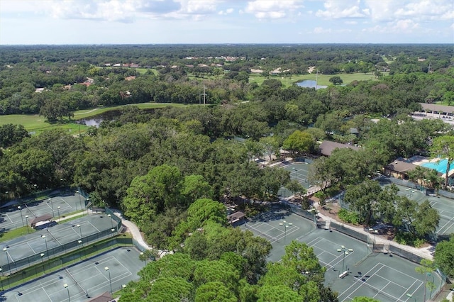 drone / aerial view featuring a water view and a view of trees