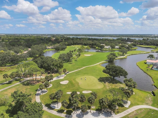 drone / aerial view featuring view of golf course and a water view