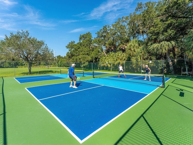 view of tennis court featuring fence