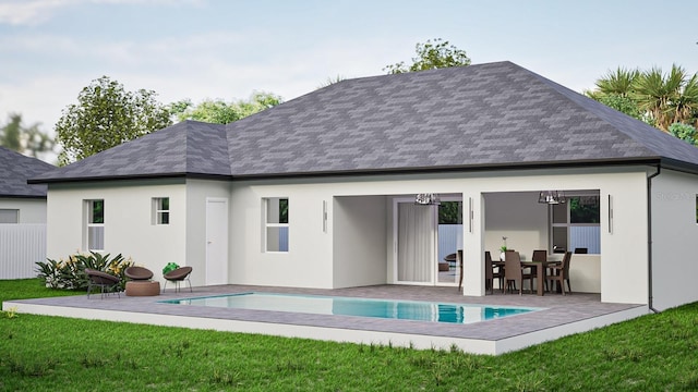 rear view of property with an outdoor pool, a lawn, roof with shingles, a patio area, and stucco siding