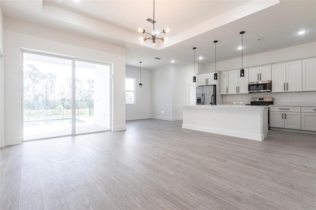 10 Mast Dr Unit 1, Placida, FL 33946 - kitchen with stainless steel appliances, a chandelier, open floor plan, light wood finished floors, and recessed lighting