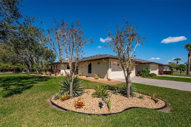 single story home with a garage, driveway, a front lawn, and stucco siding