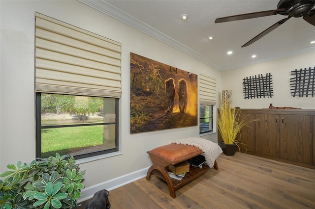 living area with baseboards, a ceiling fan, ornamental molding, wood finished floors, and recessed lighting