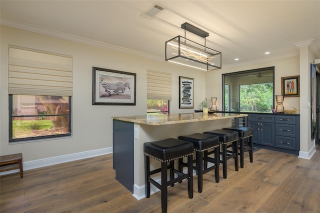 bar with baseboards, a bar, dark wood-style flooring, and crown molding