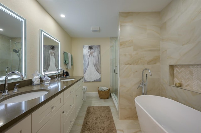 full bath featuring double vanity, a stall shower, a freestanding tub, and a sink