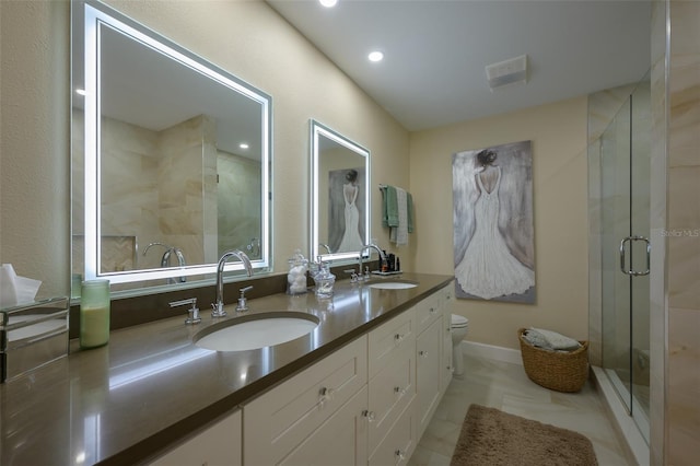 full bathroom featuring double vanity, a stall shower, visible vents, and a sink