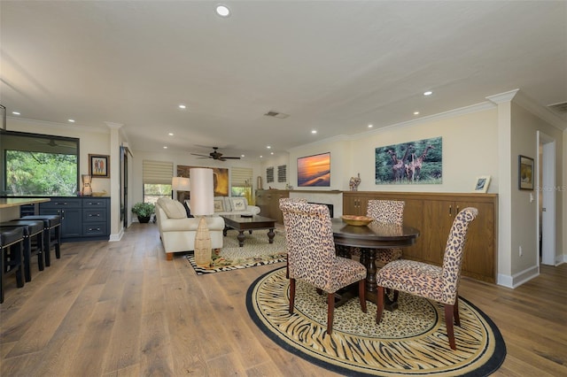 dining room featuring recessed lighting, visible vents, wood finished floors, and ornamental molding