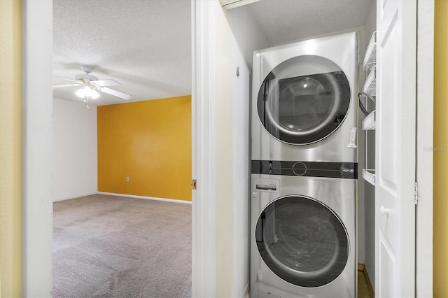 clothes washing area with a textured ceiling, laundry area, carpet flooring, and stacked washer / drying machine