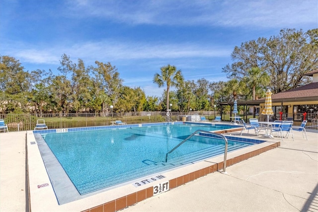 pool featuring a patio area and fence