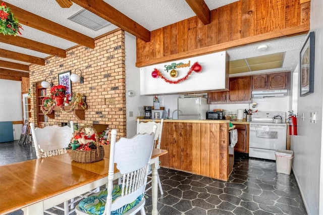 kitchen with beam ceiling, light countertops, white electric range, brown cabinetry, and under cabinet range hood