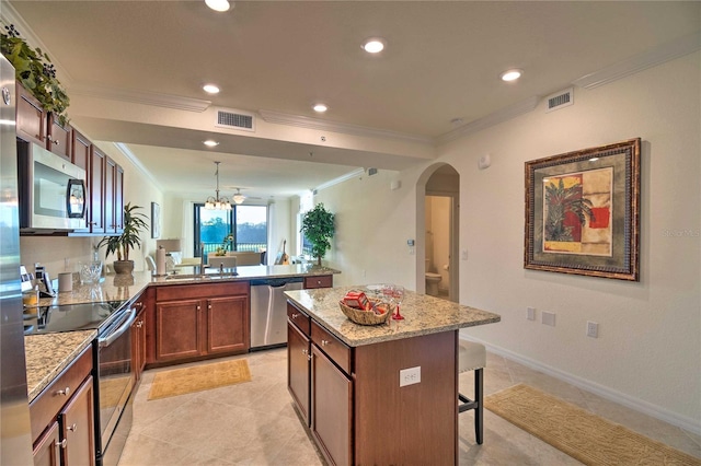 kitchen featuring a peninsula, visible vents, appliances with stainless steel finishes, and a sink