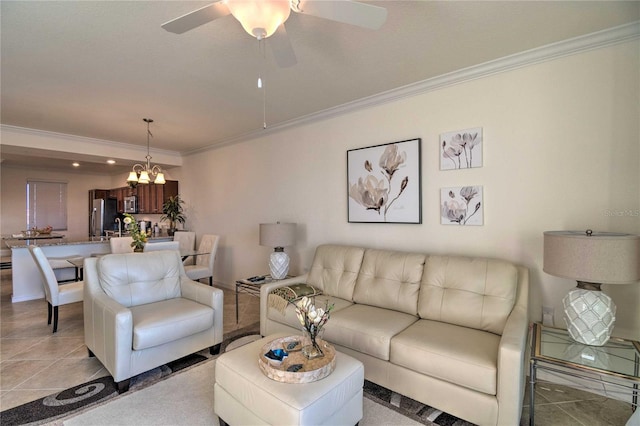 living room featuring light tile patterned floors, crown molding, and ceiling fan with notable chandelier