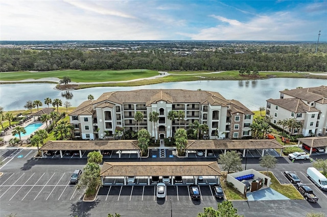 birds eye view of property featuring a water view and golf course view