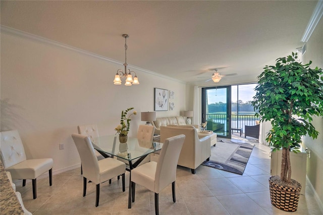 dining area featuring light tile patterned flooring, visible vents, baseboards, ornamental molding, and expansive windows