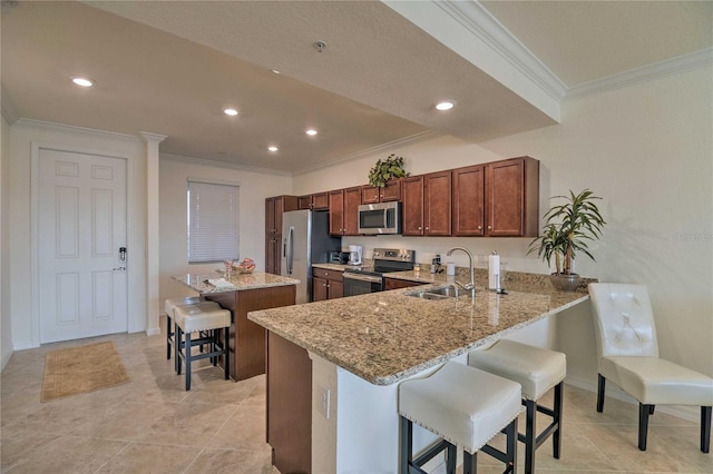 kitchen featuring a breakfast bar area, a center island, light stone countertops, stainless steel appliances, and a sink